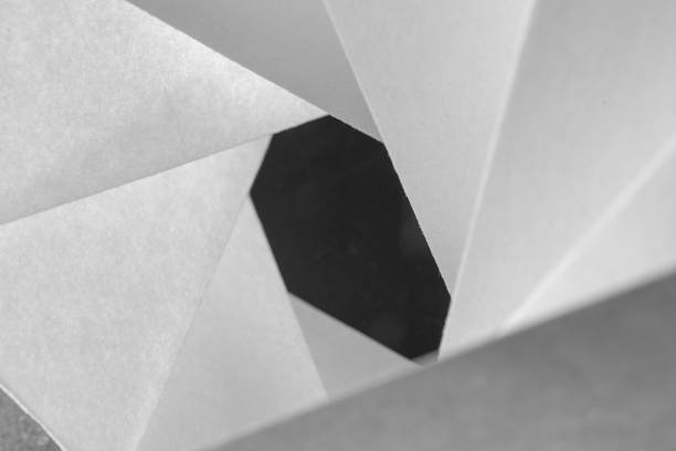 istock pieces of white folded paper on black background 2152379411
