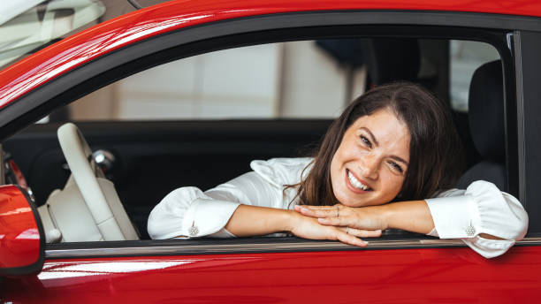 istock Young Woman Embracing Her New Car. 2152381875