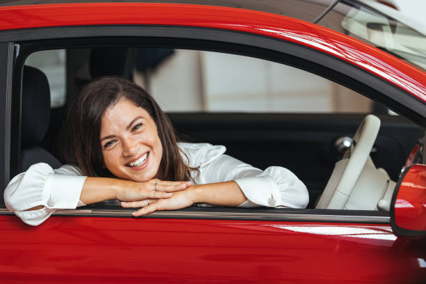 istock Young Woman Embracing Her New Car. 2152381883