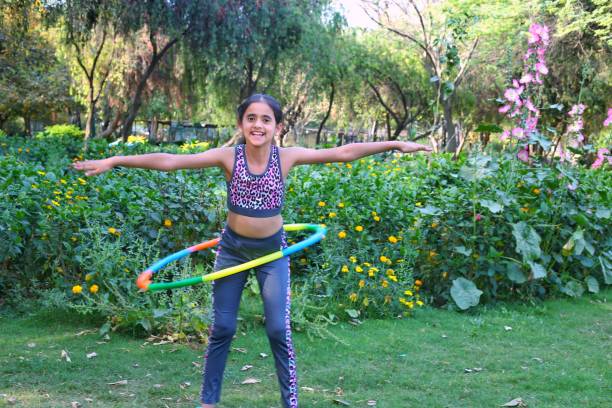 istock Girls Outdoor hula hoops At Park 2152385143