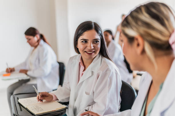 istock Young medical students women talking and stuyding during class at university 2152388084