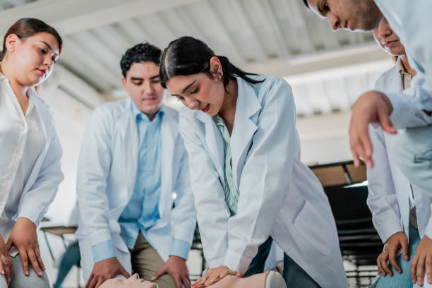 istock Young medical student woman practicing CPR during class at university 2152388996