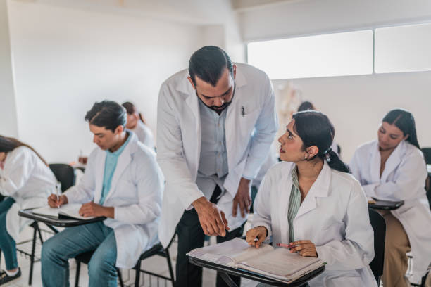 istock Mature medical professor helping student during  class at university 2152389992