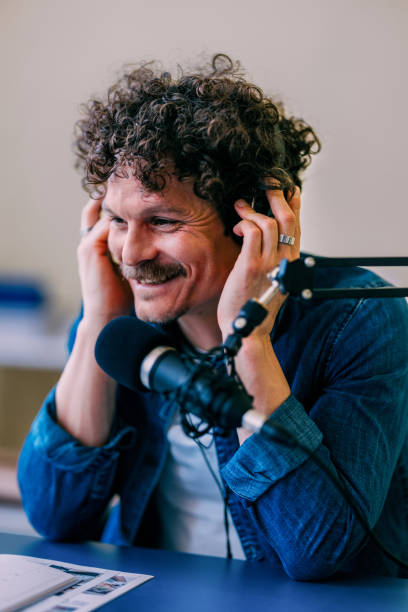 istock Curly-Haired Man Enjoying Music While Podcasting in Studio 2152391662