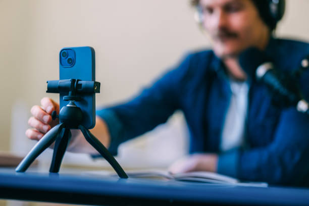 istock Young Man Video Blogging With Smartphone on Tripod 2152391663