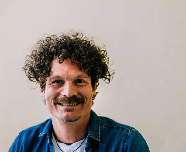 istock Smiling Man with Curly Hair in Casual Denim Jacket 2152391669