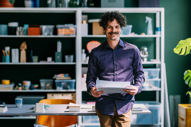istock Confident Businessman Holding Documents in Office 2152391713