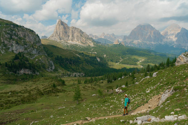 Serene determined man hiking in Dolomites at sunset in summer