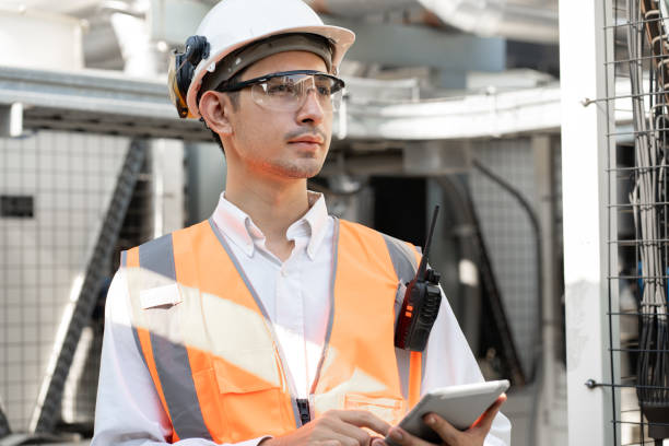 istock Asia Man engineer using walkie talkie working at rooftop building construction or working checking HVAC and installing large air conditioning system 2152401132