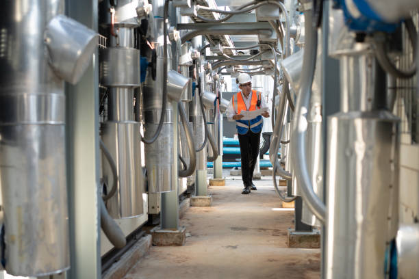 istock Engineers are inspecting a large building or industrial facility's cooling system for the air conditioning on rooftop building. 2152401223