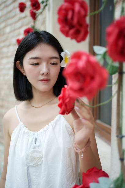 girl looking at roses