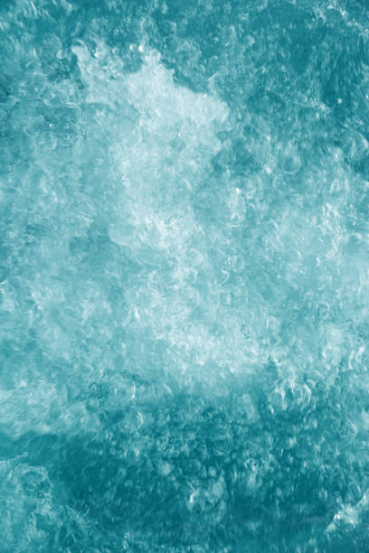 Bubbling water texture, flow thermal water as abstract background macro photo, spa and wellness theme, gentle ripples and gurgling on blue turquoise aquatic surface, sea color gradient