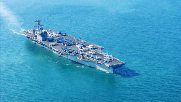 istock . Nuclear Navy ship, Military navy ship carrier full loading fighter jet aircraft for prepare troops. nuclear carrier running in the ocean 2152409055