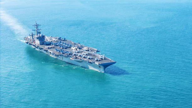 istock . Nuclear Navy ship, Military navy ship carrier full loading fighter jet aircraft for prepare troops. nuclear carrier running in the ocean 2152409059