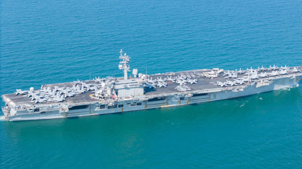 istock . Nuclear Navy ship, Military navy ship carrier full loading fighter jet aircraft for prepare troops. nuclear carrier running in the ocean 2152409072