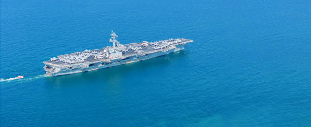istock . Nuclear Navy ship, Military navy ship carrier full loading fighter jet aircraft for prepare troops. nuclear carrier running in the ocean 2152409088