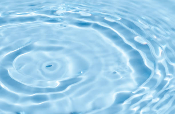 istock Background summer natural blue texture, clear water with ripples and splashes. Water waves in sunlight with leaf shadow, and background concept of cosmetics, moisturizer, and toner 2152409700