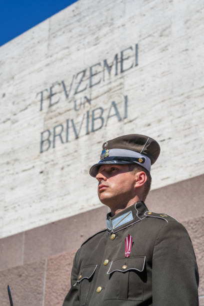 Riga, Latvia - May 4, 2024: A guard of honor guarding the Freedom Monument of Latvia, named Milda, in the Independence Day of the Republic of Latvia. The monument of Freedom is a memorial located in Riga, Latvia, honouring soldiers killed during the Latvian War of Independence . Unveiled in 1935, the 42m high monument made mainly of granite.