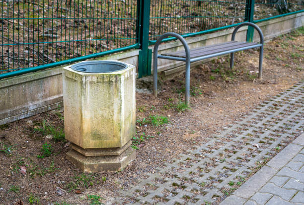 istock Concrete trash can and metal wooden bench. 2152422976