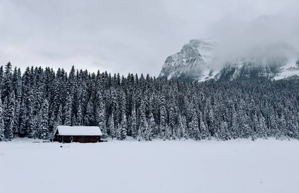 istock Log cabin in winter lake Louise 2152423070