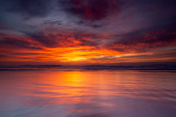 Multi coloured vibrant sky over a beach on dawn