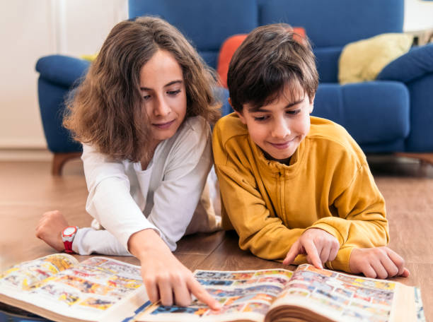 istock Children in Reading a Colorful Book Together 2152424367