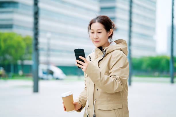 istock Modern Businesswoman Using Smartphone on the Go 2152425162