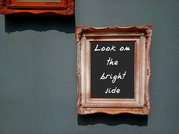 istock Photo frame with handwritten text LOOK ON THE BRIGHT SIDE, positive self talk or affirmation, to be optimistic or cheerful in spite of difficulties 2152425916