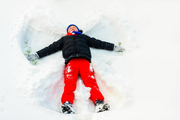 istock An angel in the snow made by a boy. 2152426131