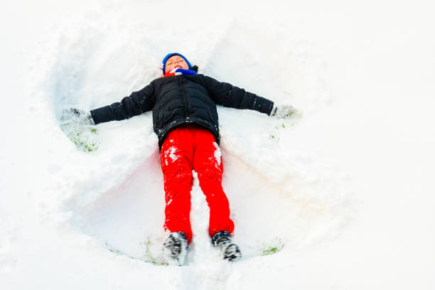 istock An angel in the snow made by a boy. 2152426149