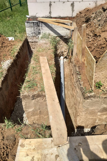 istock Sewer pipe in the trench, drainage and sewerage works on the construction site. 2152426362