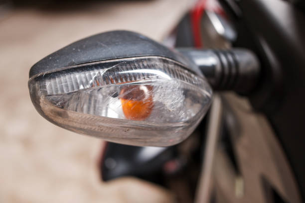 Motorcycle indicator light, luminence yellow, turn signal indicator light bright yellow orange, detail motorcyle, stock photo.