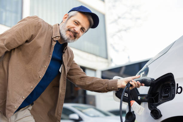 istock Man smiling and charging his electric vehicle 2152434427
