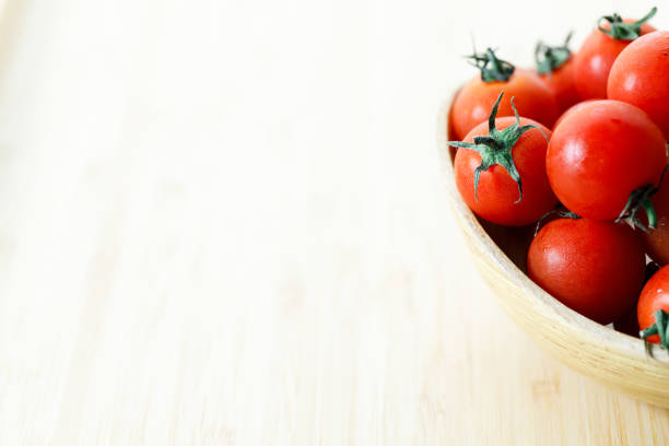 red cherry tomato on wooden background