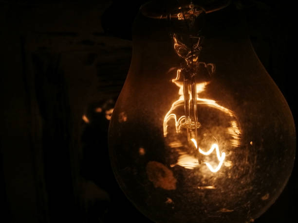 istock Incandescent lamp on a black background close-up 2152435835