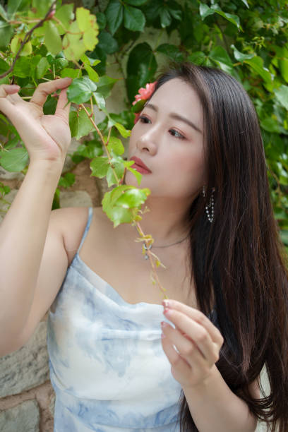 istock Asian woman holding tree branch in hand 2152436962
