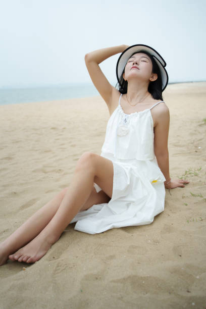 istock Young tourist sitting on the beach 2152437323