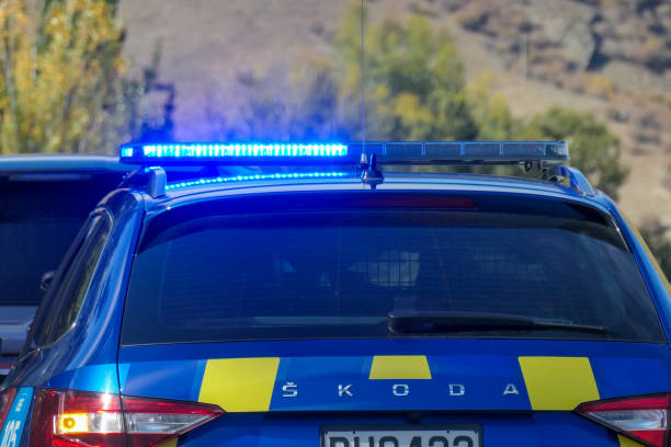 A vehicle of the New Zealand Police has pulled over a vehicle for speeding in Cromwell in central Otago in the South Island. This is a popular location for police to catch speeding motorists.  This image was taken on a sunny afternoon on 27 April 2024.