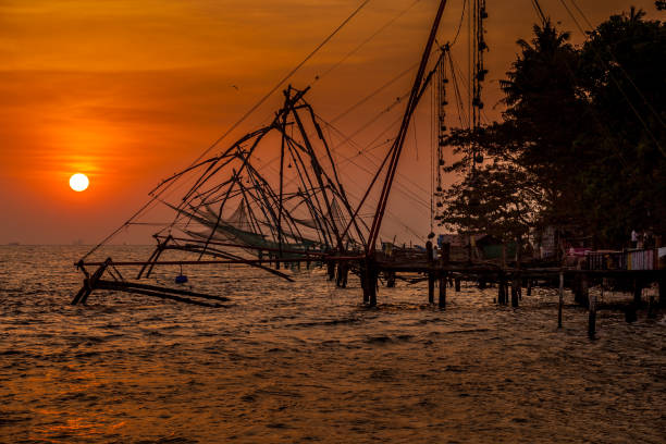 Sri Lankan fisherman throwing a fishing net, beach near Trincomalee, A cast net or a throw net, is a net used for fishing. It is a circular net with small weights distributed around its edge.