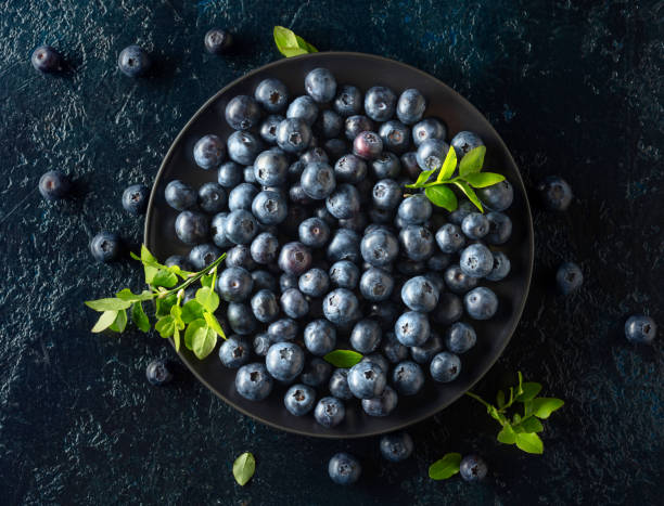 istock Blueberries in a black plate on a dark background. 2152438898