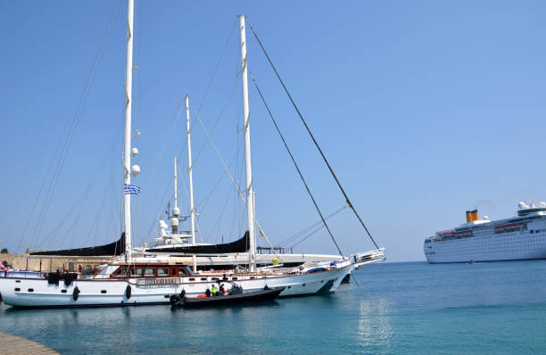 a ship is docked in the water with a cruise ship in the background