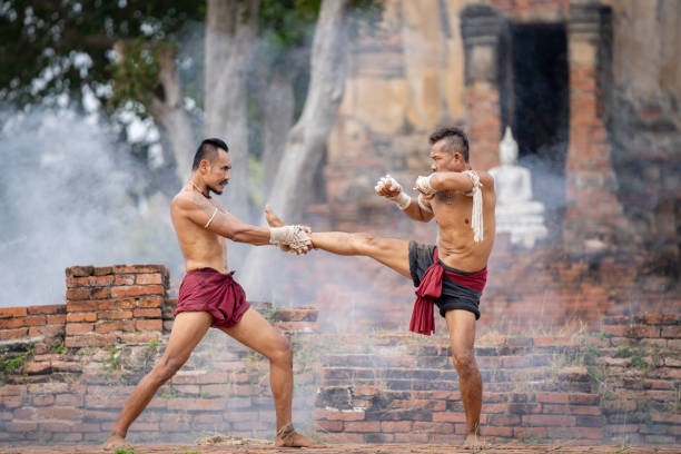 istock Asian man practicing Muay Thai, traditional Thai boxing With the backdrop of an ancient temple in Thailand, exercise concept. 2152444540