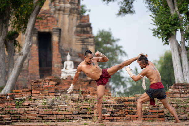 istock Asian man practicing Muay Thai, traditional Thai boxing With the backdrop of an ancient temple in Thailand, exercise concept. 2152444548