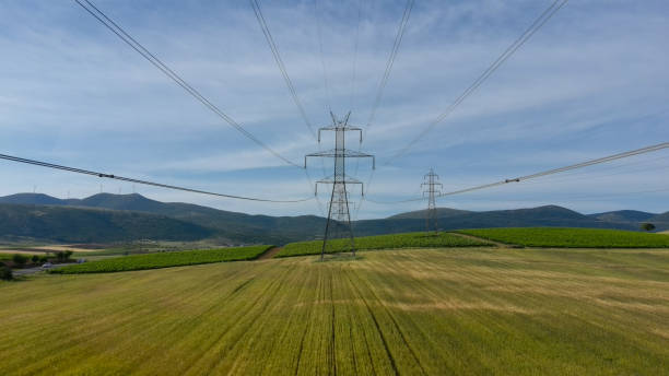 istock Electricity tower on the green field. Mountains on horizon. 2152446980