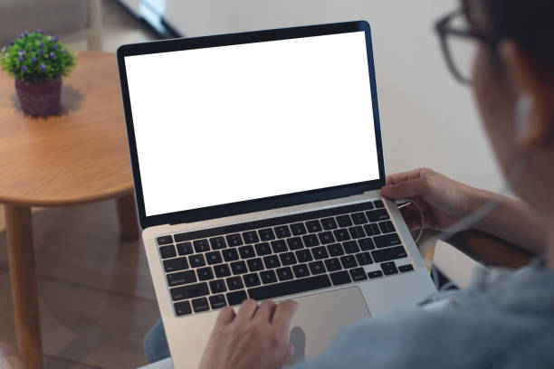 istock Mockup blank white screen laptop computer. Woman working, using laptop computer on wooden table with empty screen for advertising, template for web deign or social media marketing, freelance work 2152447000