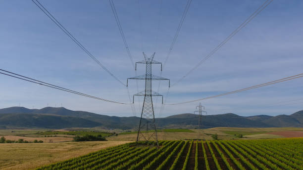 istock Electricity tower on the green field. Mountains on horizon. 2152447130