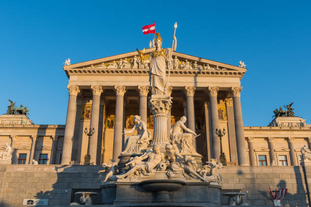 The Austrian parliament is an architectural design by Theophil Hansen, who was inspired by the Greek Revival style and was completed in 1883. Vienna, Austria