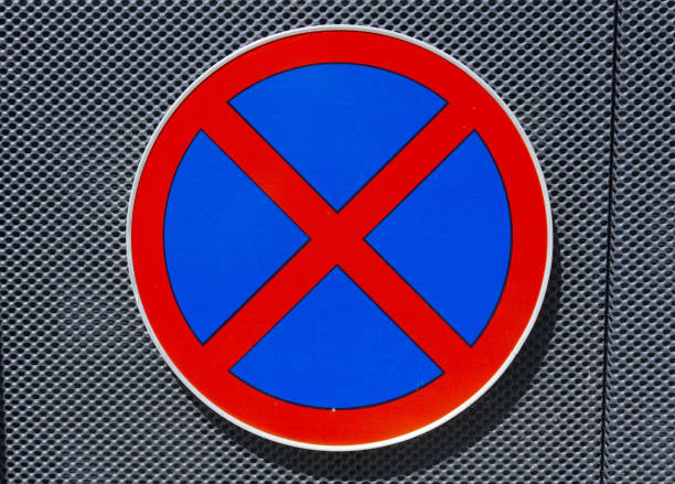 No overtaking traffic sign with trees in the background in summer.