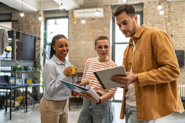 istock Young diverse colleagues having a casual business discussion 2152450264