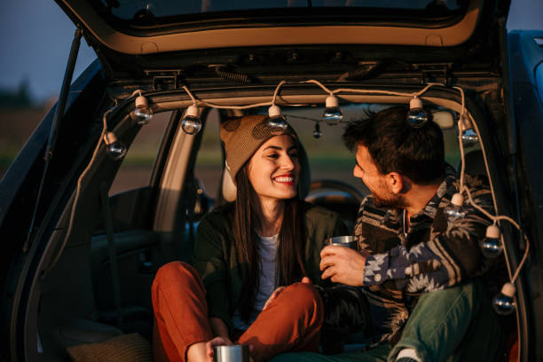 istock Young couple drinking coffee in car trunk 2152450272
